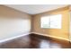 Bedroom with hardwood flooring, a large window, and neutral paint at 4727 S Texas Ave # 4727C, Orlando, FL 32839