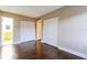 Bedroom with wood floors, spacious closets, and a neutral color palette, perfect for relaxation at 4727 S Texas Ave # 4727C, Orlando, FL 32839