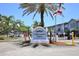 Millennium Palms Condominiums entrance sign with palm trees under blue sky at 4727 S Texas Ave # 4727C, Orlando, FL 32839