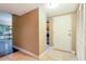 View of entrance featuring tile flooring, a white front door and access to the screened in patio at 4727 S Texas Ave # 4727C, Orlando, FL 32839