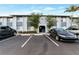 The exterior of the condominium complex includes parking and mature landscaping at 4727 S Texas Ave # 4727C, Orlando, FL 32839