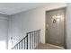 View of a gray unit front door, 4727-C, with a keypad lock and stairway at 4727 S Texas Ave # 4727C, Orlando, FL 32839