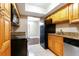 Kitchen featuring stainless steel appliances, tile floors, and wooden cabinetry at 4727 S Texas Ave # 4727C, Orlando, FL 32839