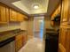 Kitchen with granite countertops, tile floor, stainless steel dishwasher, and wooden cabinets at 4749 S Texas Ave # 4749B, Orlando, FL 32839