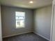 Neutral bedroom with a window looking out onto a community and a plush carpet, ready for personalization and relaxation at 5113 Prairie Preserve Run, St Cloud, FL 34772