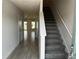 Entryway features a carpeted staircase and views of the living spaces beyond at 5113 Prairie Preserve Run, St Cloud, FL 34772