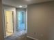 Hallway with carpet flooring, neutral-toned walls, and multiple entryways at 5113 Prairie Preserve Run, St Cloud, FL 34772