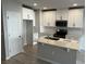 Modern kitchen with white cabinetry, stainless steel appliances, and center island with sink at 5113 Prairie Preserve Run, St Cloud, FL 34772