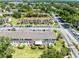 An aerial view shows the condo buildings and a well-maintained parking lot surrounded by lush green landscaping at 600 Northern Way # 1807, Winter Springs, FL 32708