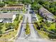 Aerial view of community entrance with manicured landscaping and signage leading to residential buildings at 600 Northern Way # 1807, Winter Springs, FL 32708
