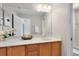 Well-lit bathroom with a large mirror, wood cabinets, and a tub shower at 600 Northern Way # 1807, Winter Springs, FL 32708