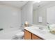 Clean bathroom featuring a vanity with wood cabinets and tub with white tile at 600 Northern Way # 1807, Winter Springs, FL 32708