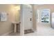 Bright entryway featuring a pedestal sink, tile flooring, and natural light at 600 Northern Way # 1807, Winter Springs, FL 32708