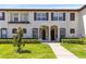 Inviting townhome exterior showcasing a well-manicured lawn and walkway at 600 Northern Way # 1807, Winter Springs, FL 32708