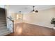 Open-concept living room featuring hardwood floors, a ceiling fan, and staircase at 600 Northern Way # 1807, Winter Springs, FL 32708