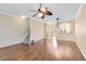 Large living room with hardwood floors, staircase, and an archway at 600 Northern Way # 1807, Winter Springs, FL 32708