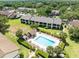 Aerial view featuring a sparkling community pool, surrounded by well-maintained landscaping and lounge chairs at 600 Northern Way # 1807, Winter Springs, FL 32708
