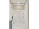Clean bathroom features a shower with glass doors, a neutral color scheme, and organized shelving at 797 Ambleside Dr, Haines City, FL 33844