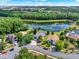 Aerial view of homes near a lake and lush green spaces, showcasing a peaceful neighborhood setting at 80 White Marsh Cir, Orlando, FL 32824