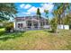 Spacious backyard featuring a screened-in pool and lush green lawn, great for recreation at 80 White Marsh Cir, Orlando, FL 32824