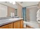 Cozy bathroom featuring a shower-tub combo with a blue floral curtain, a single vanity, and tile floors at 80 White Marsh Cir, Orlando, FL 32824