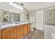 Well-lit bathroom featuring a double vanity, tiled floors, and a glass-enclosed shower at 80 White Marsh Cir, Orlando, FL 32824
