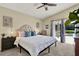 Comfortable bedroom featuring a cozy bed, neutral walls, and convenient access to the patio at 80 White Marsh Cir, Orlando, FL 32824