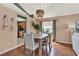 Traditional dining room with wood floors, rattan light fixture, and view to the kitchen at 80 White Marsh Cir, Orlando, FL 32824