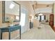 Bright entryway with tiled floors, a decorative table with mirror, and a closet to hang your coat at 80 White Marsh Cir, Orlando, FL 32824