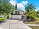 Charming two-story home featuring a three-car garage and beautiful palm trees at 80 White Marsh Cir, Orlando, FL 32824