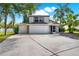 Charming two-story home featuring a three-car garage and lush landscaping at 80 White Marsh Cir, Orlando, FL 32824