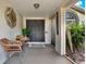 Inviting front porch with double doors, seating, and decorative welcome sign at 80 White Marsh Cir, Orlando, FL 32824