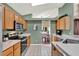 Bright eat-in kitchen features tile flooring, wood cabinets, and stainless appliances at 80 White Marsh Cir, Orlando, FL 32824