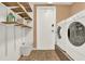 Functional laundry room with washer, dryer, shelving, tile floor and ample storage space at 80 White Marsh Cir, Orlando, FL 32824