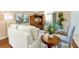 A cozy living room features comfortable seating, stylish decor, and plenty of natural light from the window at 80 White Marsh Cir, Orlando, FL 32824