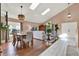 Bright, open-concept living room with skylights and wood flooring adjacent to the dining area at 80 White Marsh Cir, Orlando, FL 32824