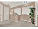 Open loft area with neutral carpet, view of the downstairs, and closet for extra storage at 80 White Marsh Cir, Orlando, FL 32824