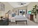 Serene main bedroom features soft lighting, plush bedding, and a view of the outdoors through sliding doors at 80 White Marsh Cir, Orlando, FL 32824