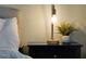 Close up of modern nightstand featuring a contemporary lamp, decorative pot, and dark wood finish at 80 White Marsh Cir, Orlando, FL 32824