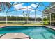 Screened pool overlooking serene lake, perfect for relaxation and enjoying the natural beauty at 80 White Marsh Cir, Orlando, FL 32824