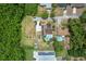 Aerial view of property showcasing a home, pools, large yards, and surrounding trees at 820 Hobson St, Longwood, FL 32750