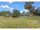 Expansive backyard featuring an in-ground pool, mature palm trees, and well-maintained landscaping at 820 Hobson St, Longwood, FL 32750