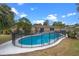 Backyard featuring an in-ground pool, mature trees, and well-maintained landscaping at 820 Hobson St, Longwood, FL 32750