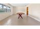 A dining room with a long wooden table with tiled floor and a large window at 820 Hobson St, Longwood, FL 32750