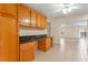 Kitchen featuring wooden cabinets, dark countertops, and an open layout into the living area at 820 Hobson St, Longwood, FL 32750