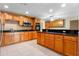Well-lit kitchen with black countertops and oak wooden cabinetry at 820 Hobson St, Longwood, FL 32750
