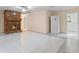 Bright living room with brick fireplace, tiled floors, and white refrigerator at 820 Hobson St, Longwood, FL 32750