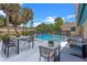 Poolside patio with outdoor seating, grill, landscaping, and a safety fence at 820 Hobson St, Longwood, FL 32750