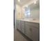 Bathroom vanity with double sinks, quartz countertop, and large mirror at 8563 Compass Point Ave, Orlando, FL 32832