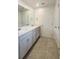 Bathroom vanity with double sinks, drawers, and a neutral color scheme at 8563 Compass Point Ave, Orlando, FL 32832